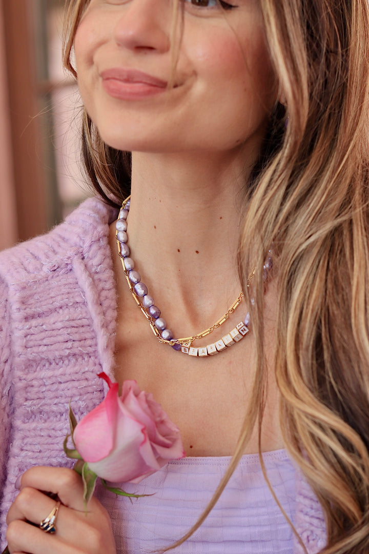 lavender pearl necklace with words sparklin on it