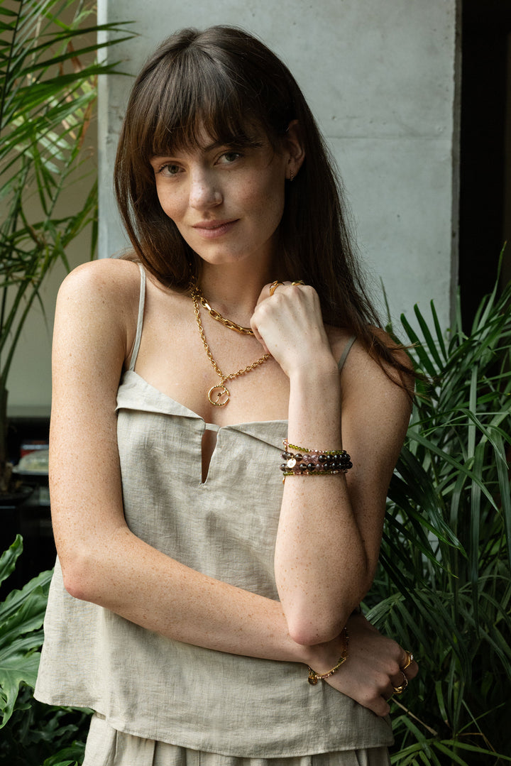 dainty layering gold jewelry with coin medallion of infinite journey symbol