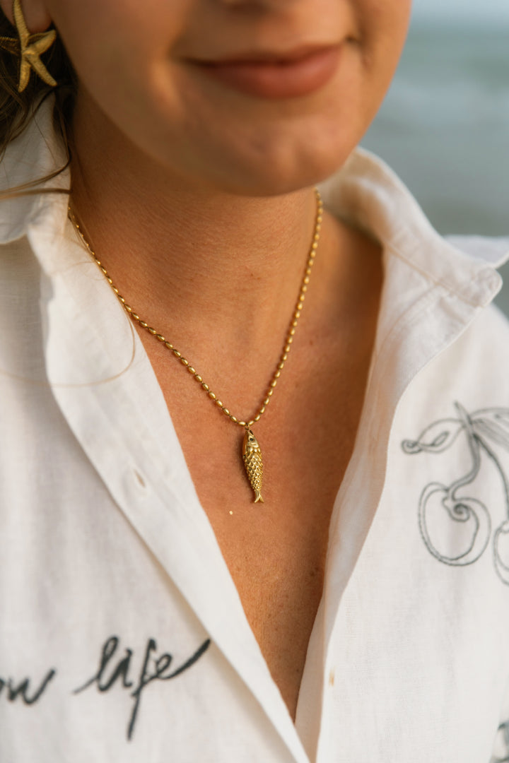 Gold fish necklace on gold water resistant beaded chain 