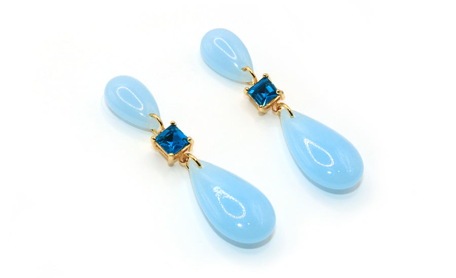 Pair of blue teardrop earrings with gold accents on a white background