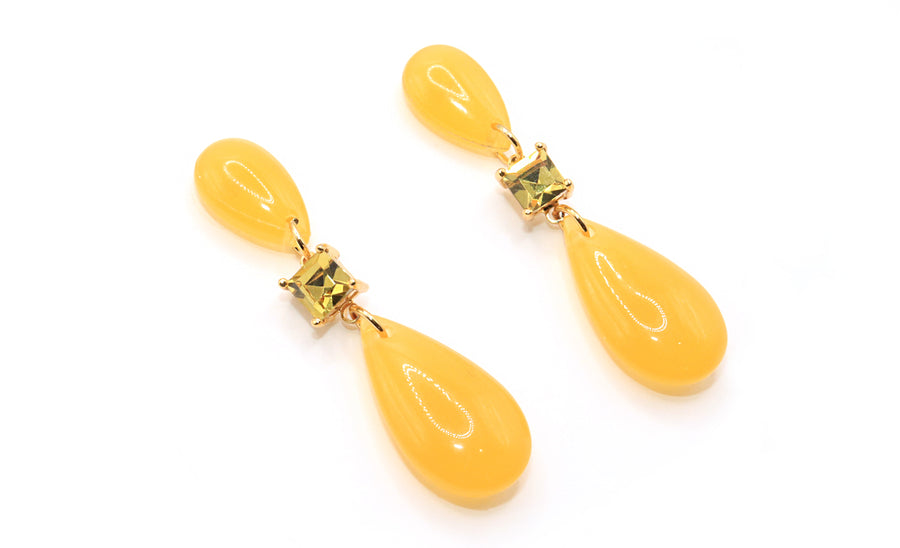 Pair of yellow teardrop earrings with gold accents on a white background