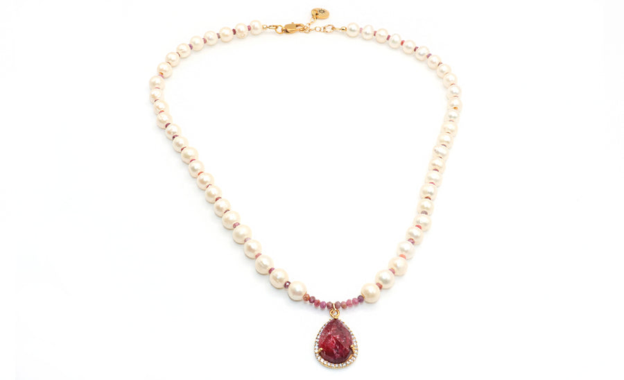 Pearl necklace with a red teardrop pendant on a white background